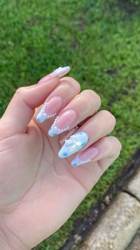 Sophisticated Pink and Blue Nail Design with Pearls and Abstract Patterns