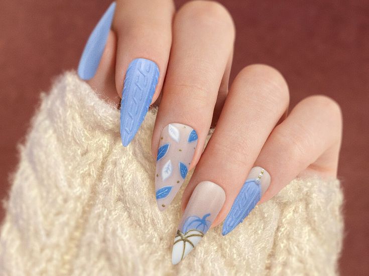 Sophisticated Light Blue and Neutral Nail Design with Intricate Patterns and Textures.