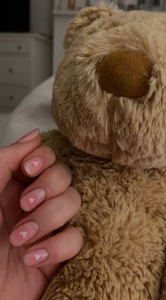 Charming Soft Pink Heart Nail Design with Cozy Teddy Bear Accents.