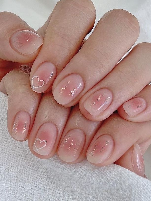 Romantic and Elegant Delicate Nail Design with Translucent Base and Minimalist Heart Accents.