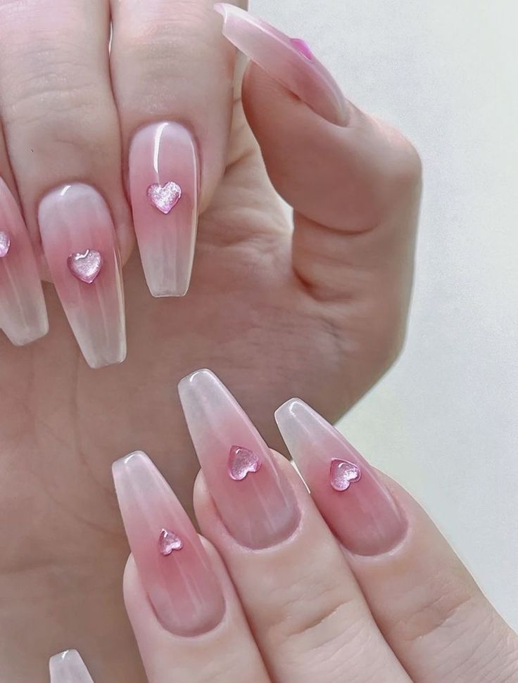 Charming Ombre Nail Design with Heart Accents for a Playful, Elegant Look.