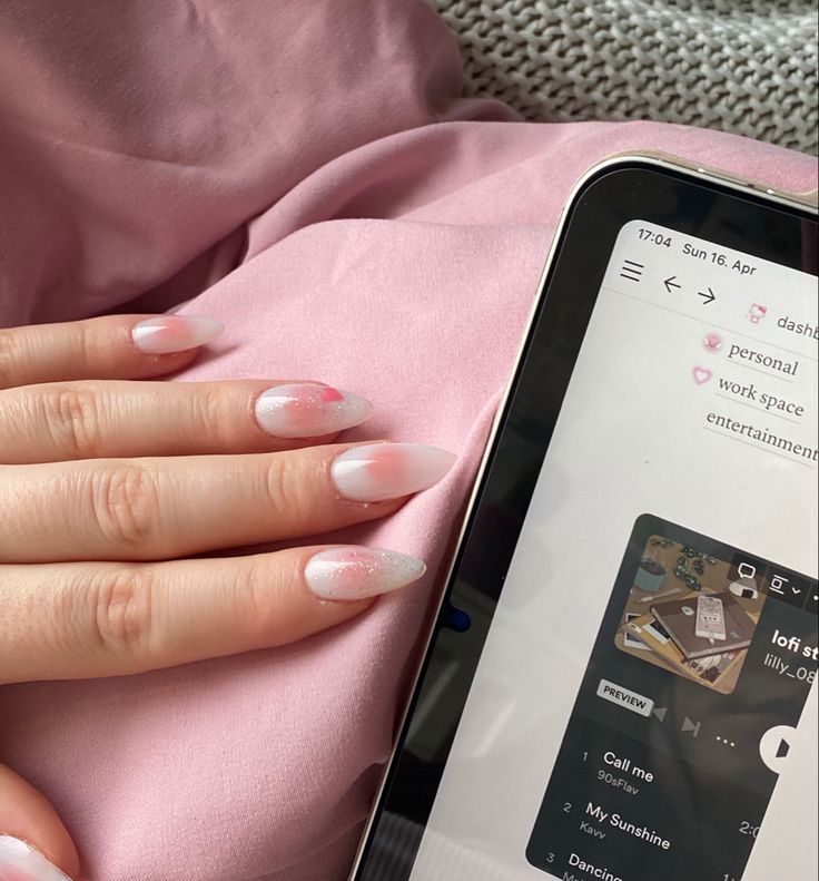 Elegant Ombre Nail Design: Soft Pink Gradient with Playful Red Accents for a Cozy Workspace.