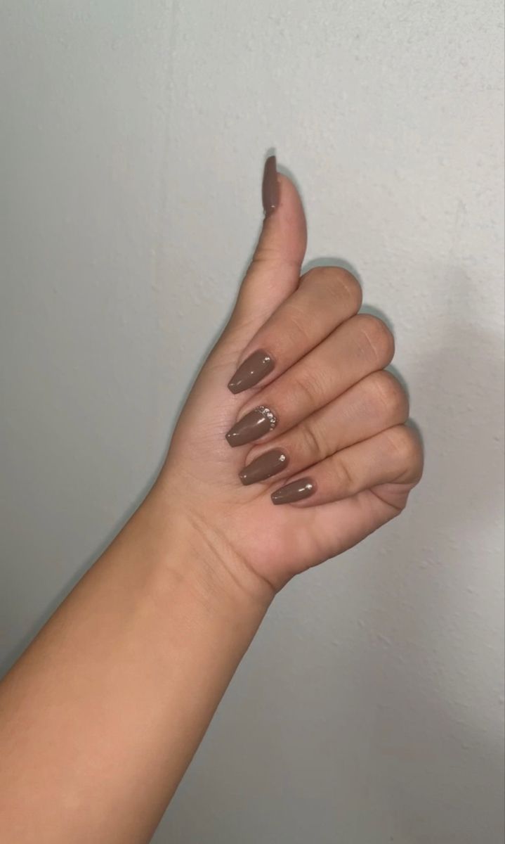 Sophisticated Glossy Brown Manicure with Delicate Embellishments for Any Occasion