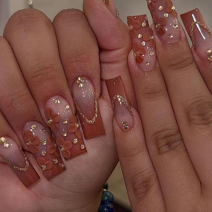 Sophisticated Peach and Nude Floral Nail Art with Gold Accents for Elegant Occasions.