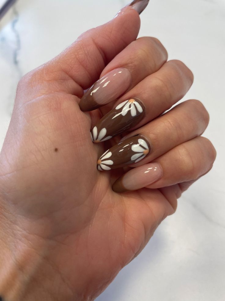 Elegant Nail Design: Warm Brown Tips with Soft Nude and White Floral Accents