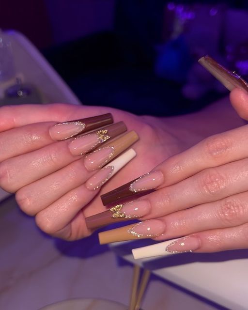 Elegant Earthy Nail Design with Shimmering Gold Accents and Soft Nude Base.