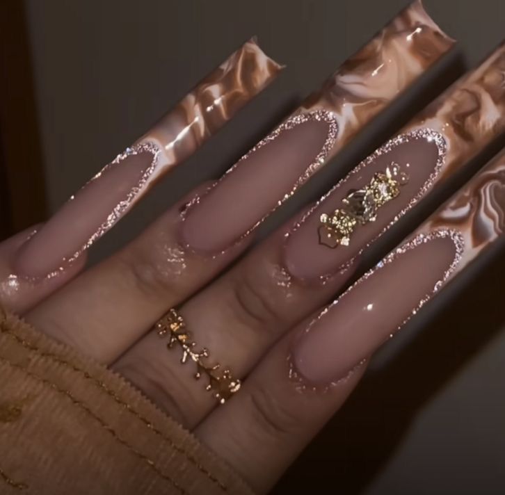 Stunning Marble-Inspired Long Nails in Warm Brown and Cream with Gold Accents.