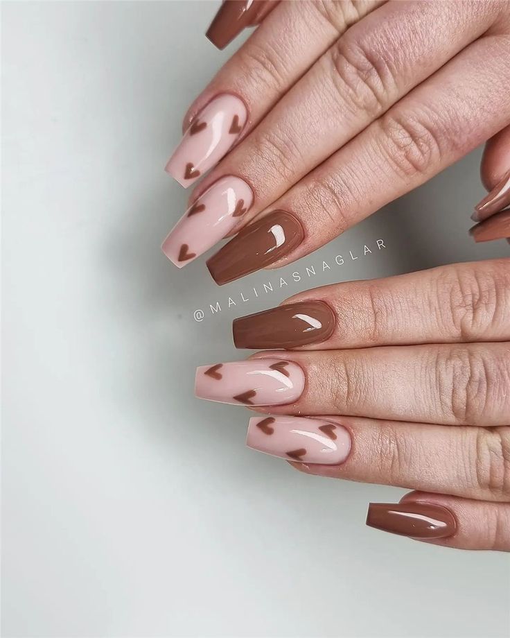 Chic Taupe and Brown Nail Design with Playful Heart Accents.