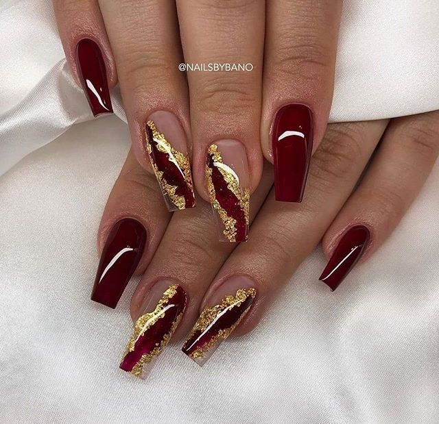 Sophisticated Deep Crimson Nail Design with Gold and Red Marbled Accents for Special Occasions