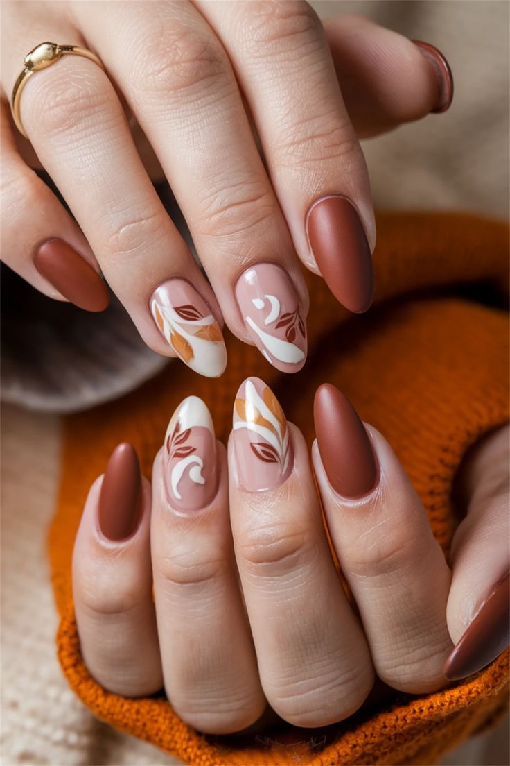 Elegant Autumn-Inspired Nail Design: Matte and Glossy Finish with Earthy Tones and Floral Accents.