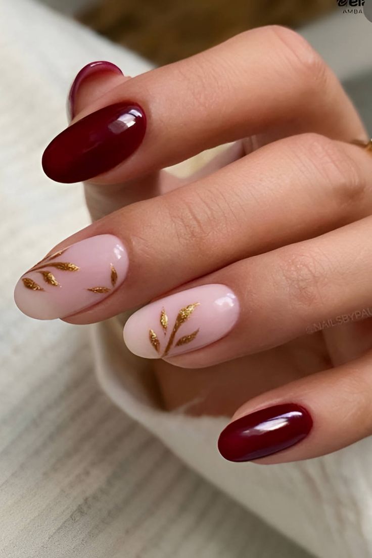 Chic Nail Design: Deep Burgundy and Soft Nude with Golden Leaf Accents