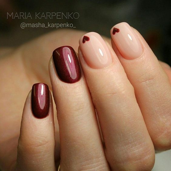 Elegant Burgundy and Nude Nail Design with Playful Heart Accents