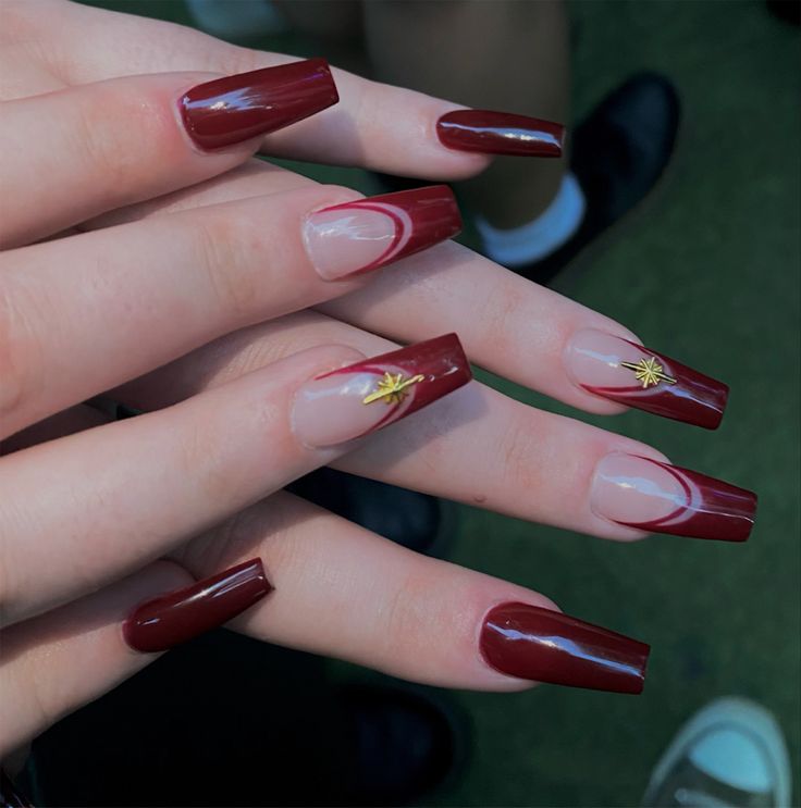 Elegant Burgundy and Nude Nail Design with Gold Star Accents