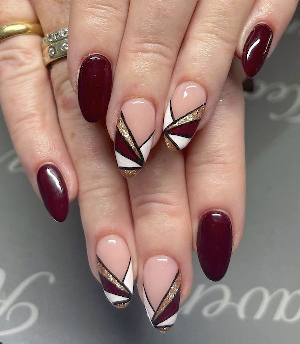 Sophisticated Nail Art: Deep Burgundy and Nude with Geometric Patterns and Gold Accents