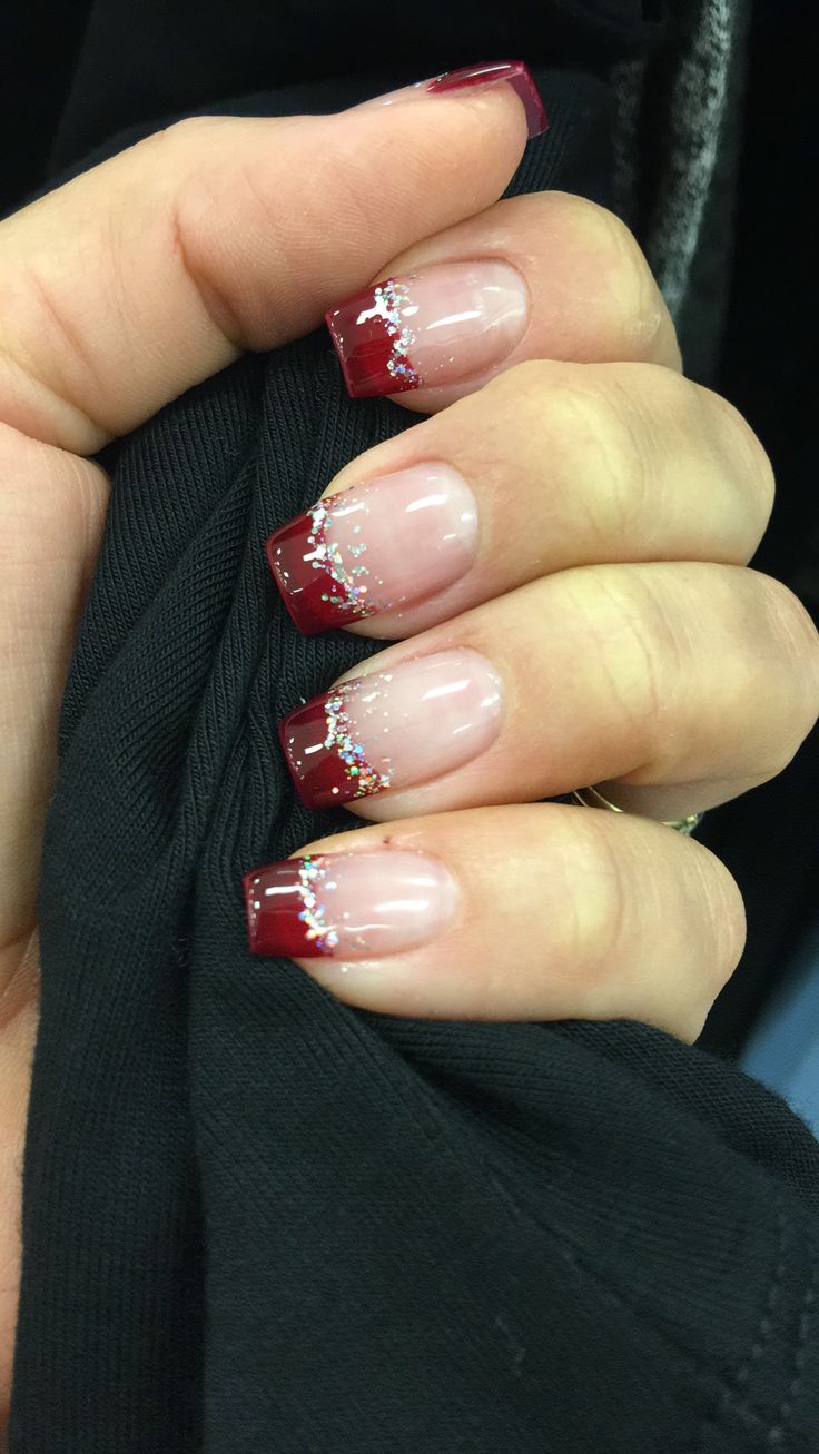 Sophisticated French Tip Nail Design with Deep Burgundy and Iridescent Glitter Accents.