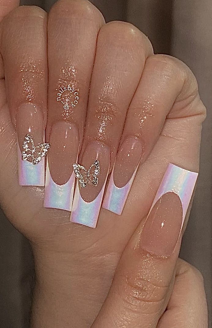 Sophisticated Ombre Nail Design with Iridescent Finishes and Whimsical Butterfly Embellishments.