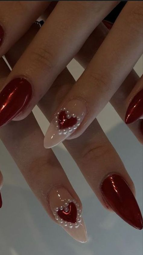 Bold Red Nail Design with Elegant Heart Motifs for Romantic Occasions.