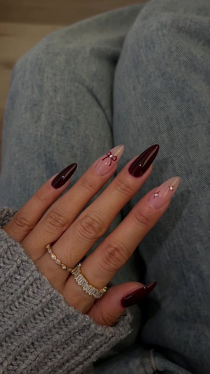 Chic Almond-Shaped Nail Design: Deep Burgundy and Soft Nude with Floral Accents