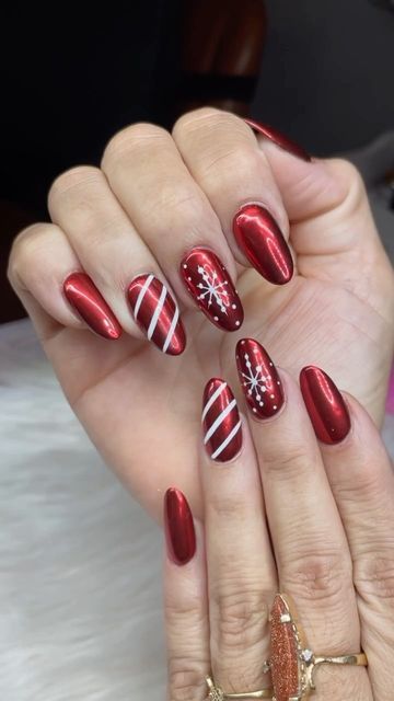 Festive Glossy Red Nail Design with Playful White Accents for Seasonal Celebrations