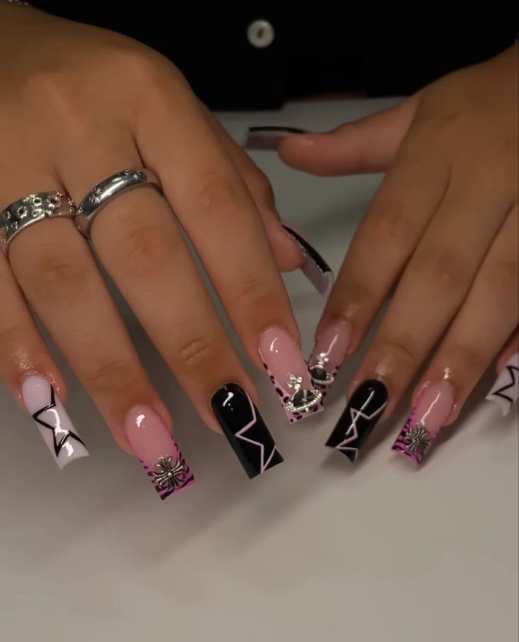 Chic Pink, Black, and White Nail Art with Geometric Patterns and Floral Accents