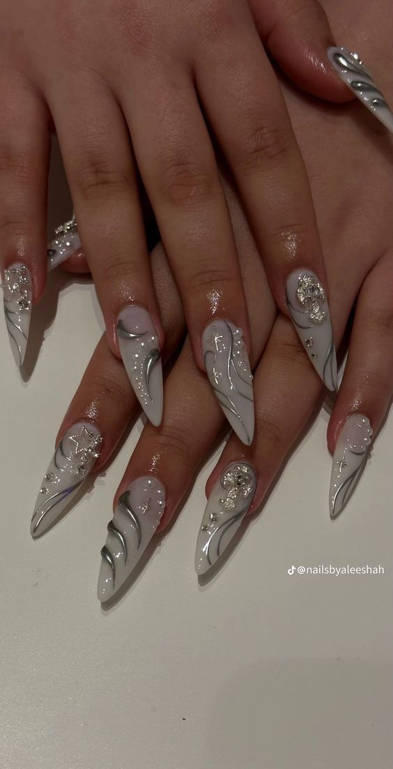 Chic Elegant Nail Design: Long Pointed Tips with Silver Swirls and Jewel Embellishments