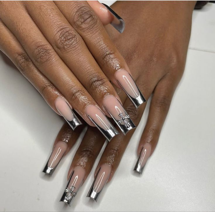 Sophisticated Nude Nail Design with Metallic Silver Tips and Floral Accents.