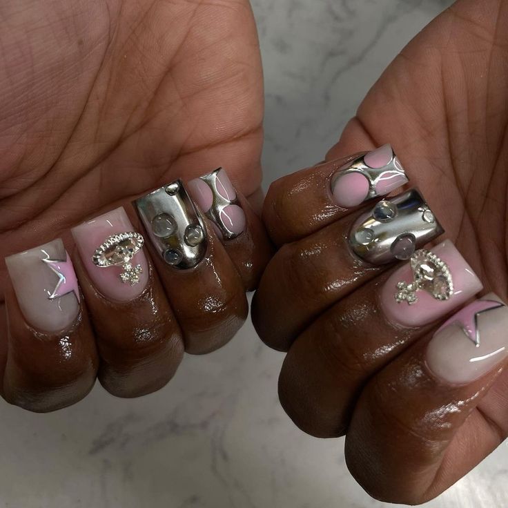 Sophisticated Playful Nail Design with Soft Pink, Clear Finishes, and Metallic Silver Accents.