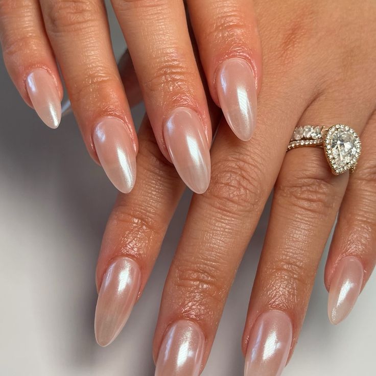 Sophisticated Almond-Shaped Nails with Iridescent Finish and Timeless Nude Hue.