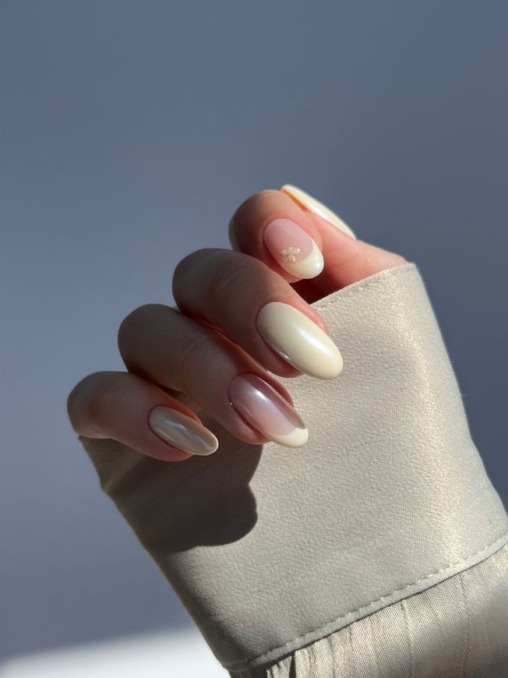 Sophisticated Pastel Nail Design with Ombre Effects and Delicate Accent.