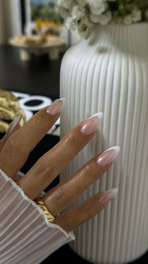 Elegant Almond-Shaped Ombre Nail Design with Translucent Nude Base and Crisp White Tips.