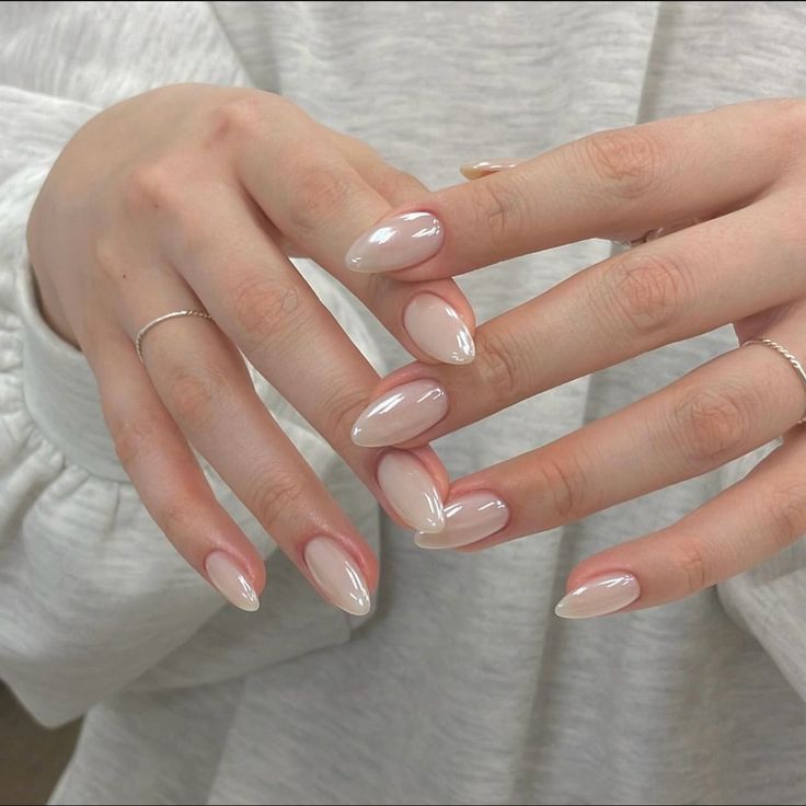 Elegant Ombre Almond-Shaped Nails: Subtle Nude to Creamy White Gradient for Minimalist Sophistication.