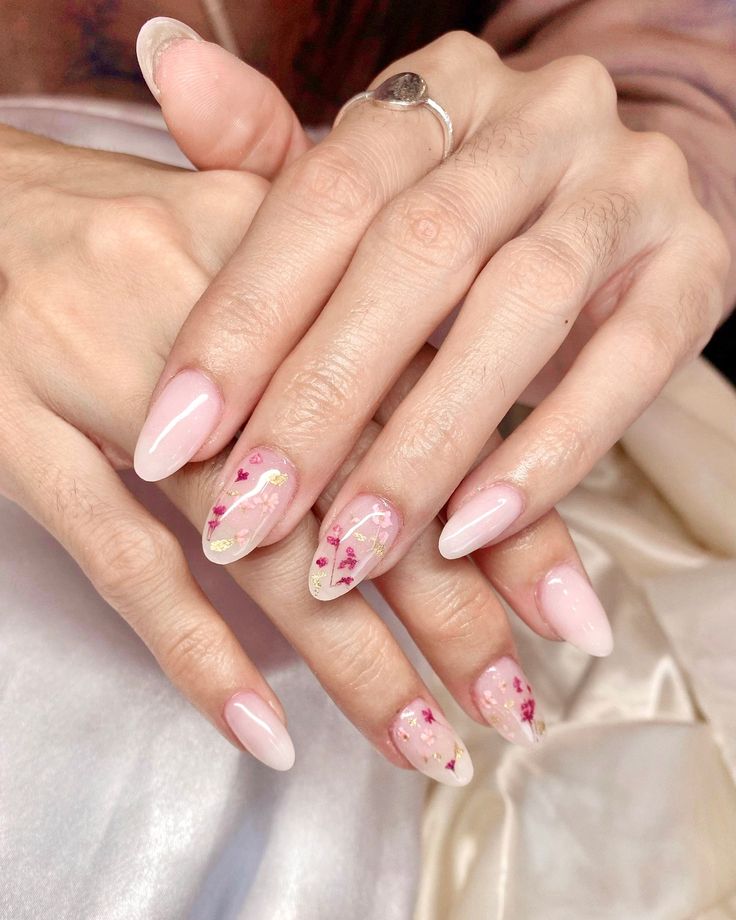 Chic Nail Design: Subtle Pink Tones with Matte and Glossy Finishes and Delicate Floral Accents.