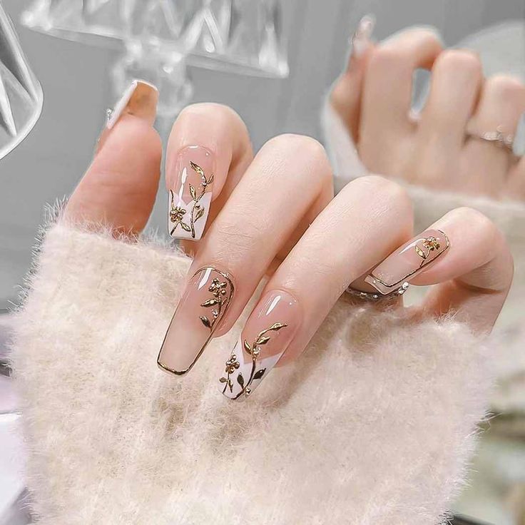 Chic Floral Nail Design with Transparent Base and Gold Accents for Sophistication.