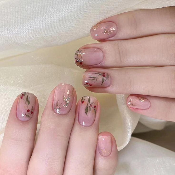 Elegant Floral Nail Design with Rose Accents and Gold Foil on Soft Nude Base.