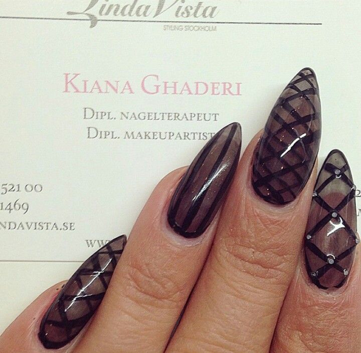 Sophisticated Elongated Geometric Nail Design with Deep Black Polish and Mesh Pattern Embellishments.