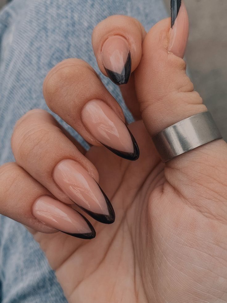 Chic Almond-Shaped Nails: Natural Nude Base with Sleek Black Tips