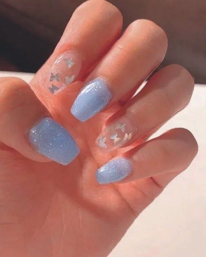 Whimsical Pastel Blue Butterfly Nail Design with Glittery Accents