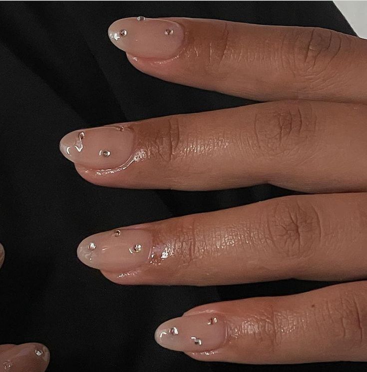 Sophisticated Nude and Glossy White French Tip Nails with Crystal Embellishments