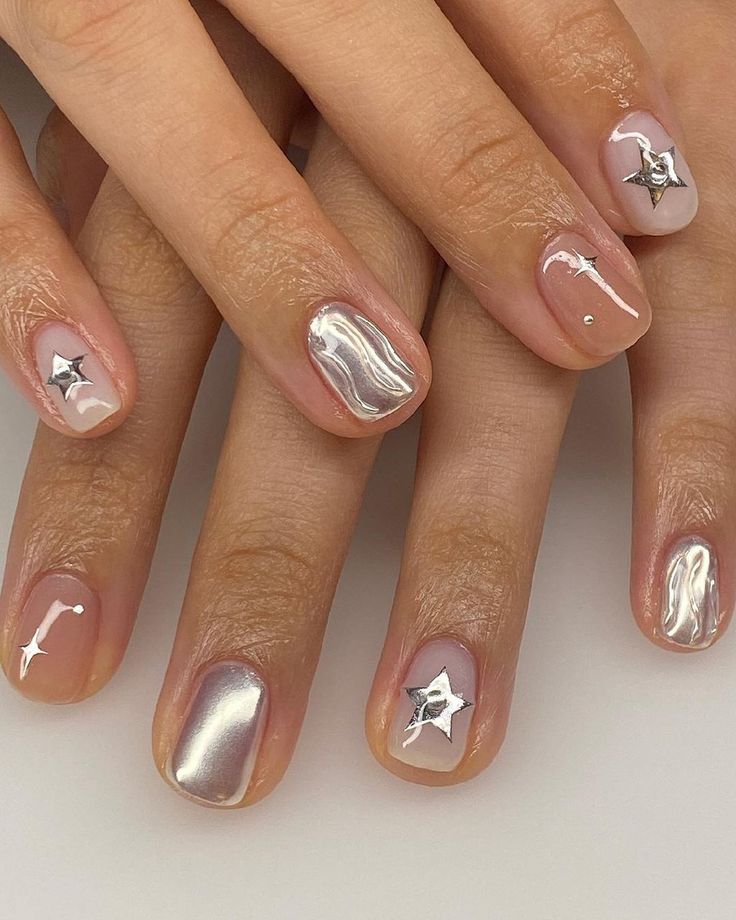 Chic Metallic & Shimmer Nail Design with Elegant Silver Stars and Wavy Patterns.