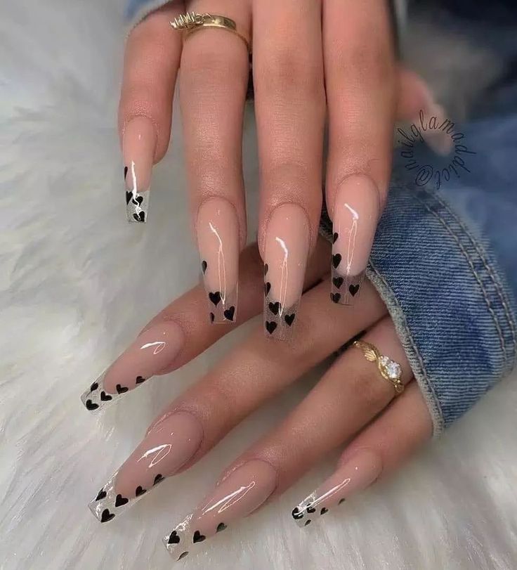 Chic Nude and Black Heart Tip Nail Design with Sophisticated Elongated Shape.