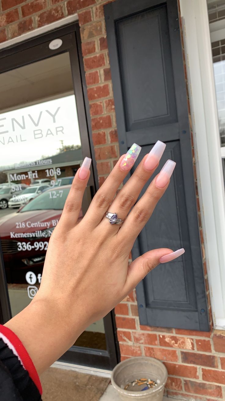 Elegant Soft Pink Gradient Long Nails with Unique Accent Design.