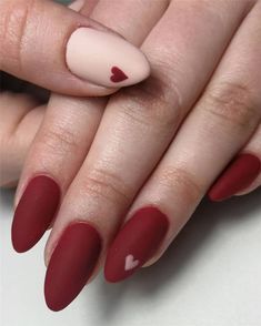 Elegant Valentine's Nail Design: Matte Red and Nude Shades with Heart Accents.