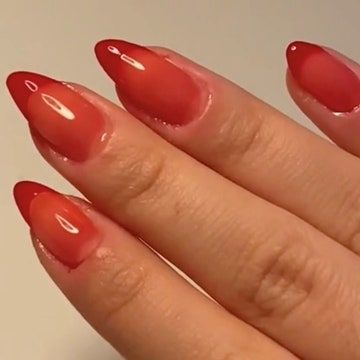 Elegant Ombre Nail Design: Striking Gradient of Vivid Reds with Translucent Finish and Glossy Shine.