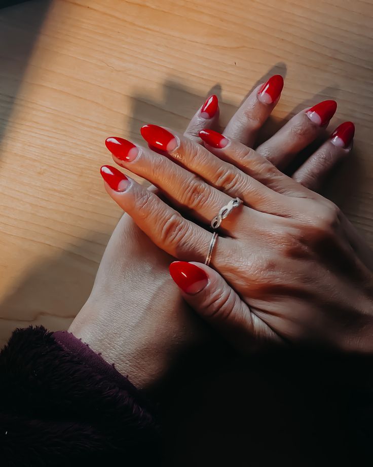 Chic Red Nail Design with Pointed Tips and Glossy Finish for a Modern Look.