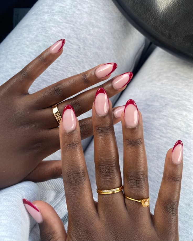 Chic Nail Design: Subtle Nude Base with Striking Red Tips and Mixed Finishes for Any Occasion.