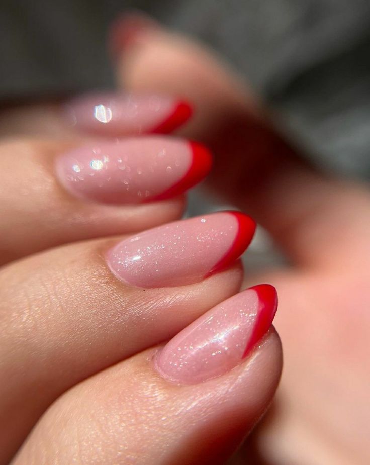 Chic Manicure: Elegant Nude Base with Bold Red Tips for a Modern Twist on French Style.