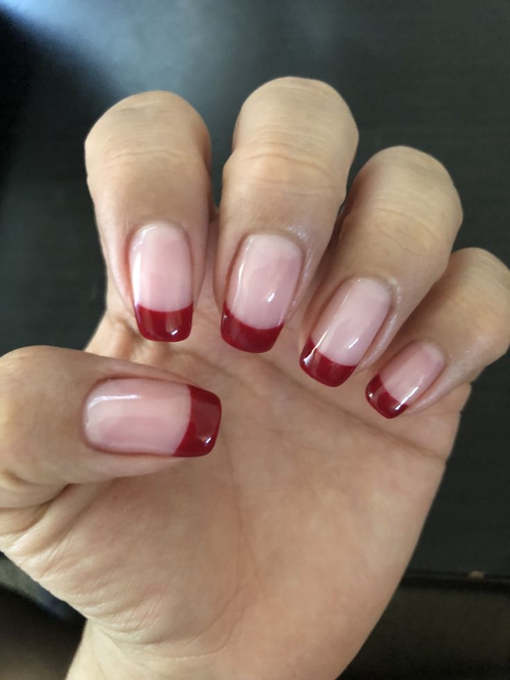 Bold Elegance: Red-Tipped French Manicure for a Striking Statement.