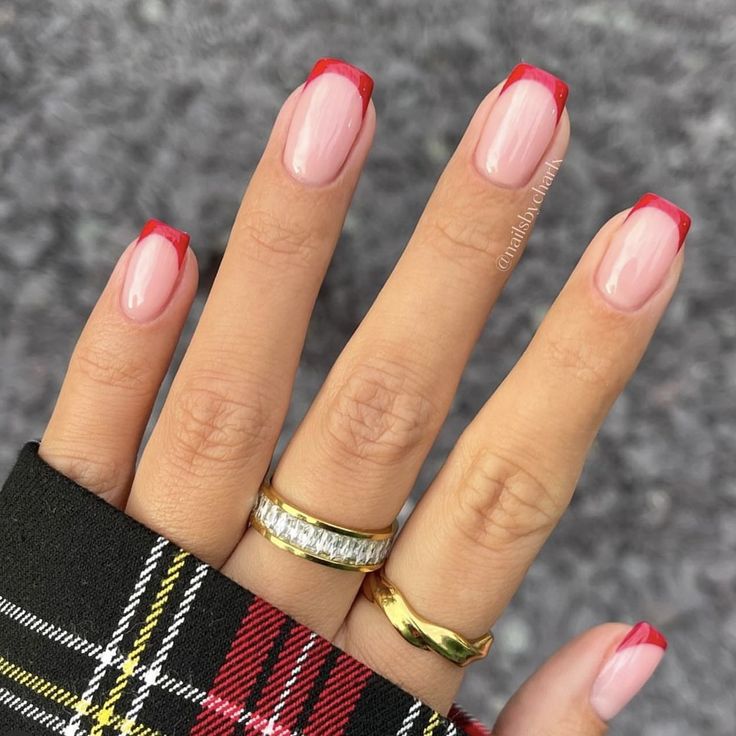 Elegant French Tip Manicure with Vibrant Red Edge and Glamorous Gold Accents