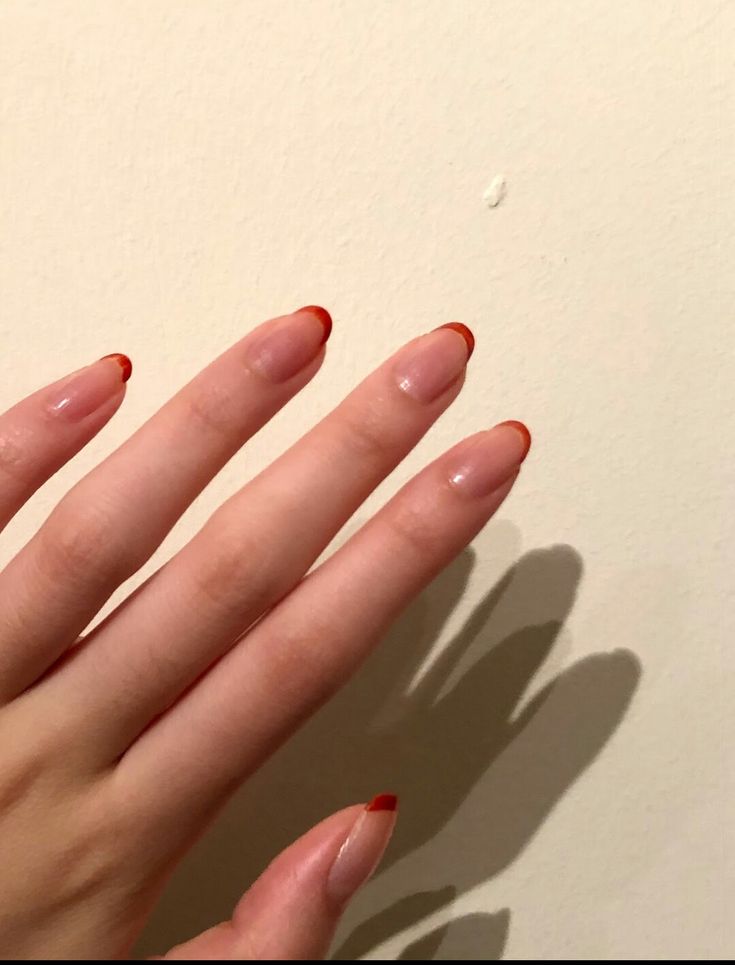 Sophisticated Modern French Manicure: Subtle Nude Base with Bold Red Tips