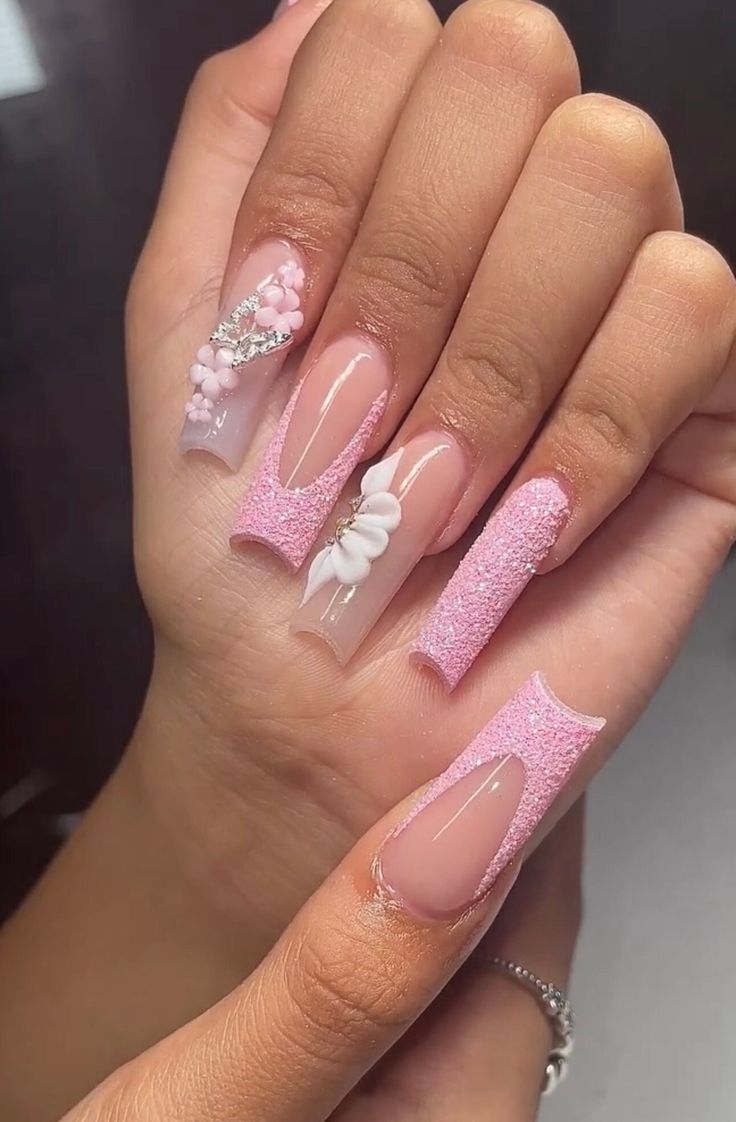 Elegant Pink Nail Design with Sparkly Tips and Artistic Accents.